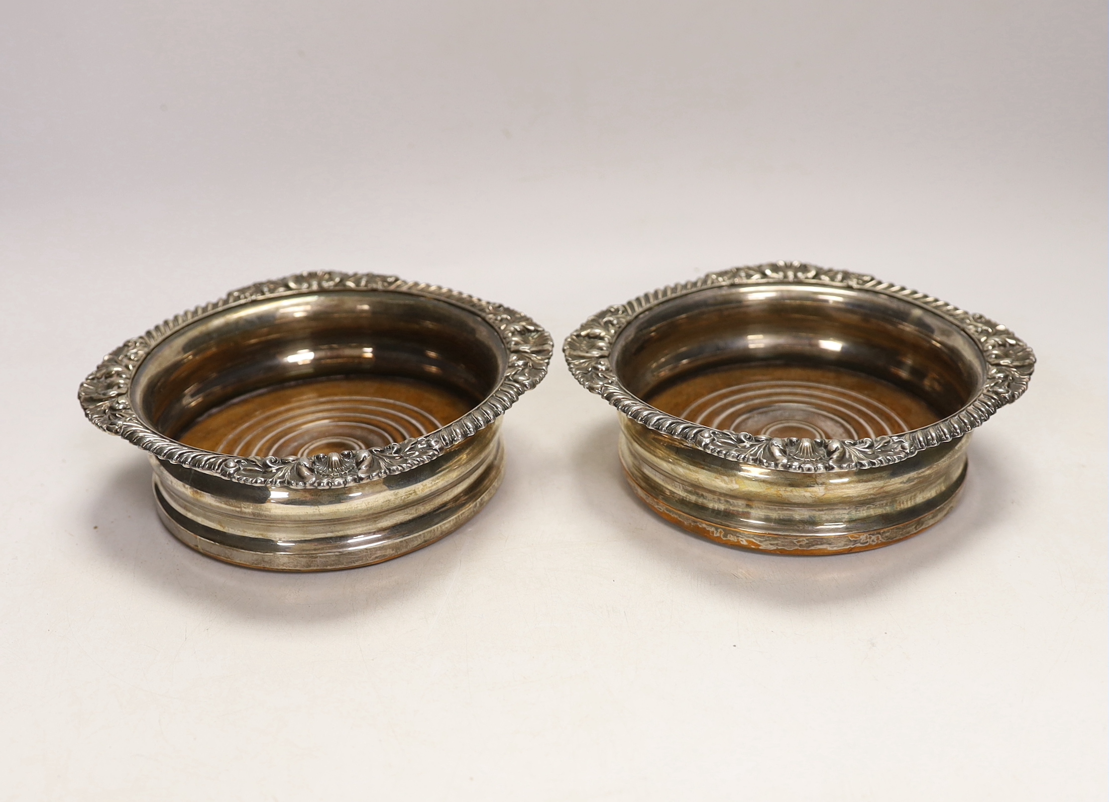 A pair of Victorian silver plated wine coasters, 17cm in diameter